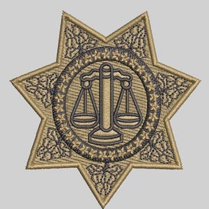 May include: A gold embroidered patch in the shape of a six-pointed star with a dark gray scale of justice design in the center.