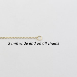 May include: A gold-colored chain with a small circular clasp at the end. The chain is thin and delicate, with a repeating pattern of small links. Text on the image reads: "3 mm wide end on all chains."