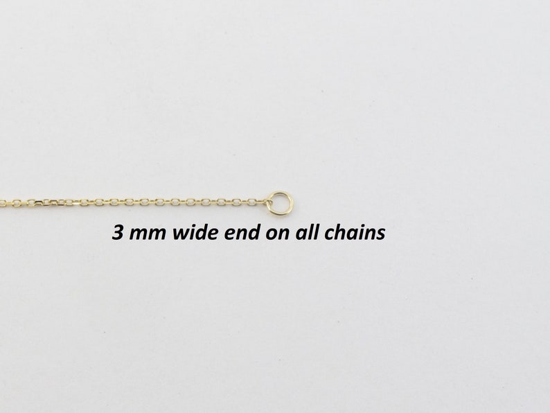 May include: A gold-colored chain with a small circular clasp at the end. The chain is thin and delicate, with a repeating pattern of small links. Text on the image reads: "3 mm wide end on all chains."