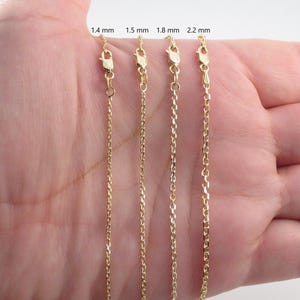 May include: Four gold-colored chain necklaces with lobster claw clasps are displayed. The chains vary in thickness, with labels indicating 1.4 mm, 1.5 mm, 1.8 mm, and 2.2 mm. The chains are shown against a light background.