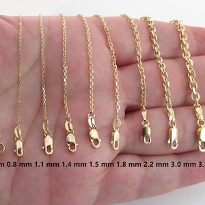May include: A selection of gold-colored chain necklaces with varying thicknesses, ranging from 0.6 mm to 3.7 mm. Each chain is displayed with its clasp and measurement in millimeters. The chains are presented against a neutral background.