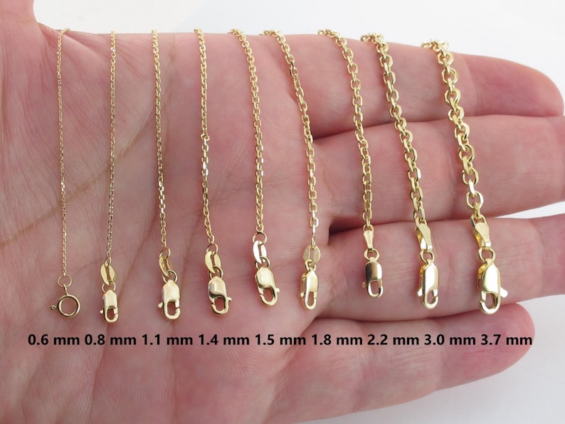 May include: A selection of gold-colored chain necklaces with varying thicknesses, ranging from 0.6 mm to 3.7 mm. Each chain is displayed with its clasp and measurement in millimeters. The chains are presented against a neutral background.