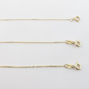 May include: Three gold chains of different lengths, each with a lobster clasp.