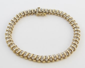 May include: A gold tennis bracelet with a row of small diamonds set in a twisted design.