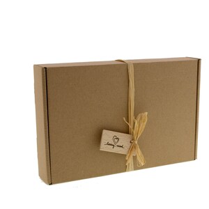 May include: A brown cardboard box with a string bow and a wooden tag that says "loving wood".