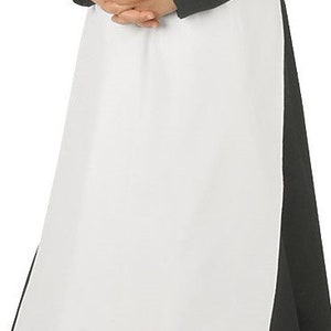 May include: A long white apron worn over a black long-sleeved garment. The apron features a wide waistband and a smooth, plain white fabric panel that extends down to the hem, contrasting against the solid black fabric of the underlying clothing.