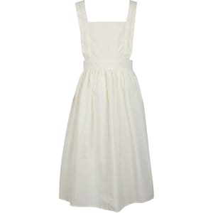 May include: A solid off-white pinafore dress featuring a square neckline, wide shoulder straps, and a fitted waistband that transitions into a gathered, knee-length skirt. The garment is constructed from a plain, light-coloured fabric with a simple design.