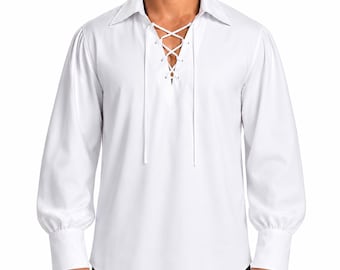 May include: A long-sleeved white shirt featuring a pointed collar and a front placket with a lace-up closure using white cord. The sleeves are full and gathered at the wrists with wide, structured cuffs, creating a classic, historical-inspired look.