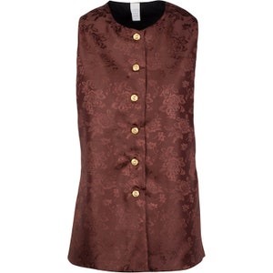 May include: A sleeveless vest in a deep brown shade featuring a tonal floral jacquard pattern throughout. The garment has a round neckline, a front button closure with five circular gold-toned buttons, and a solid black interior lining.