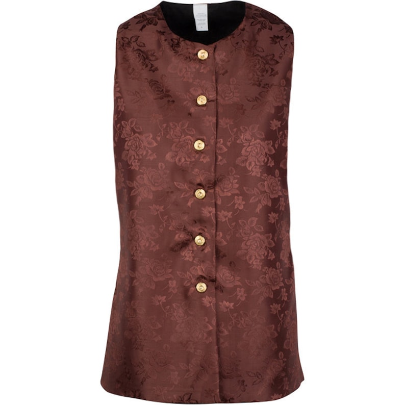 May include: A sleeveless vest in a deep brown shade featuring a tonal floral jacquard pattern throughout. The garment has a round neckline, a front button closure with five circular gold-toned buttons, and a solid black interior lining.