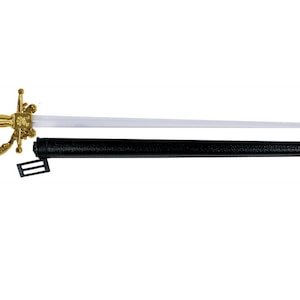 May include: A toy sword with a metallic gold-colored hilt and guard, featuring a long, straight, translucent white blade with a rounded tip. The sword is accompanied by a black, textured scabbard that includes a small black plastic belt loop.
