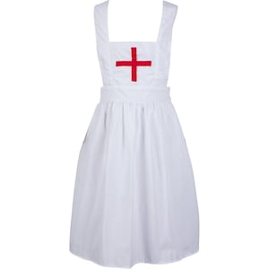 May include: A white apron featuring a square bib with a red cross emblem centred on the chest. The apron has wide shoulder straps, a fitted waistband, and a gathered skirt that falls to a knee-length hem, providing a clean and uniform appearance.
