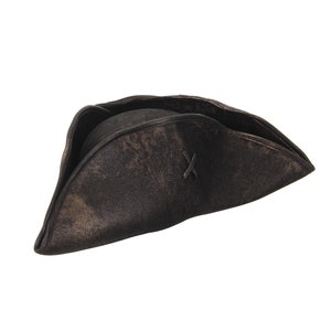 May include: A dark brown, weathered tricorn hat with a distressed finish and a visible X-shaped stitch detail on the side. The hat features a wide, upturned brim that forms a triangular shape, constructed from a textured material with dark shading.