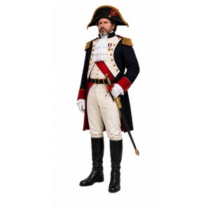 May include: A historical military-style uniform featuring a dark blue tailcoat with red cuffs, gold epaulettes, and brass buttons. It includes white breeches, a ruffled jabot, a black bicorne hat with gold trim, a red sash, white gloves, and a sword.