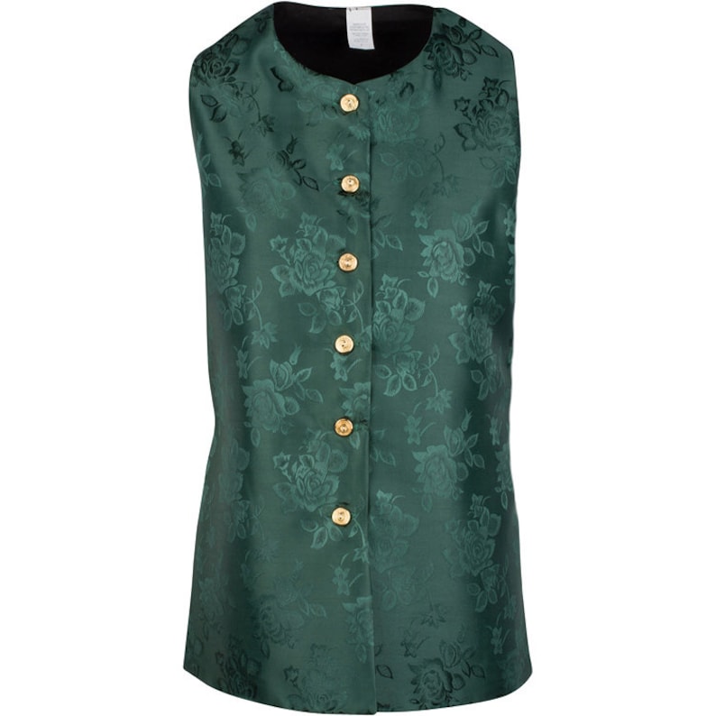 May include: A sleeveless vest in a deep emerald green color featuring a tonal floral jacquard pattern throughout. The garment has a round neckline, a black interior lining, and a front button closure with five circular gold-toned metal buttons.