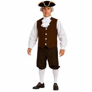 May include: A colonial-style costume featuring a brown vest with four light-colored buttons, a white long-sleeved shirt with ruffled cuffs and a lace jabot, brown knee-length breeches, white stockings, black buckled shoes, and a black tricorn hat.