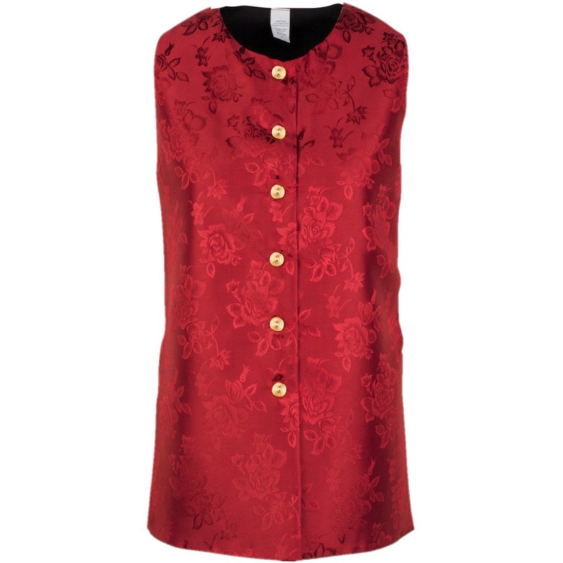 May include: A sleeveless vest in a deep red fabric featuring a tonal floral jacquard pattern. The garment has a round neckline, a black interior lining, and a front closure secured by five round, polished gold-toned buttons arranged vertically.