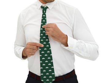May include: A dark green tie with a repeating white pattern of a stylized building design. The tie is being adjusted by a person wearing a white dress shirt and black pants. The tie is a classic accessory.