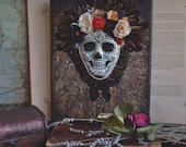 Skull Art Day of the Dead, Halloween. Mexican Catrina. Relief mixed media artwork of sugar skull with flowers and feathers. Macabre art.