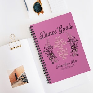May include: Pink spiral bound notebook with the text "Dance Goals" in a decorative font. The notebook has a floral design and the text "If it doesn't challenge you, it won't change you."  The notebook also has the text "Name Goes Here 2024-2025 Season".