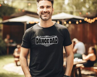 May include: A black t-shirt with a white graphic that says "Loud & Proud Dance Dad" with a globe and stars.
