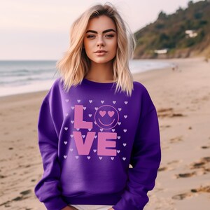Valentine&#39;s Day Sweatshirt, Smiley Love Heart Face Top, Cute Pink and Purple Happy Heart Day Unisex Heavy Blend™ Crewneck Sweatshirt