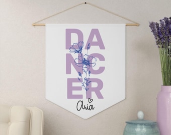 May include: A white banner with the word "DANCER" in purple letters with a floral design in blue. The banner has a heart and the name "Aria" written below the word "DANCER".