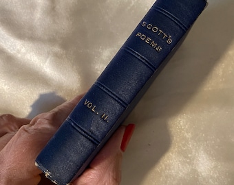 May include: A navy blue hardcover book with gold lettering that reads "SCOTT'S POEMS VOL. II."