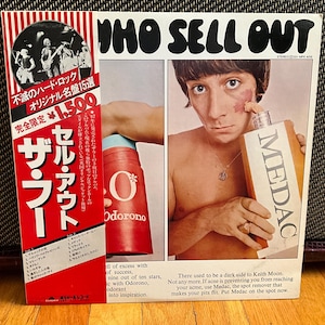 May include: A vintage vinyl record cover for the album "Who Sell Out" by The Who. The cover features a photo of a man with acne holding a bottle of Medac spot remover. The text on the cover reads "There used to be a dark side to Keith Moon. Not any more. If acne is preventing you from reaching your acme, use Medac, the spot remover that makes your pits flit. Put Medac on the spot now."