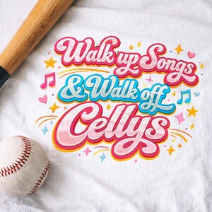 May include: White t-shirt with the text "Walk up Songs & Walk off Cellys" in pink, blue, and yellow. A baseball and a baseball bat are in the image. The design includes musical notes, stars, and hearts.