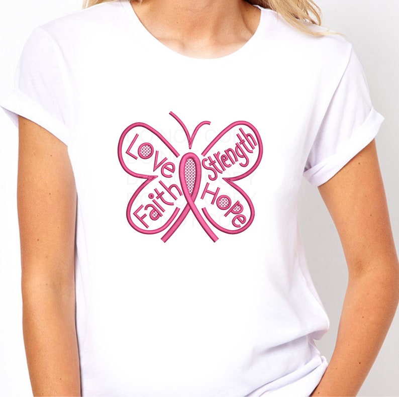 May include: White t-shirt with a pink butterfly design. The butterfly is made up of the words "Love", "Faith", "Hope", and "Strength" and a pink ribbon in the center.
