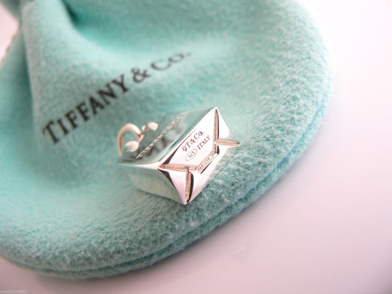 Tiffany & Co.® shopping bag charm in sterling silver with enamel finish.