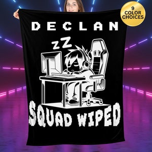 May include: Black fleece blanket with a white gamer graphic. The graphic shows a person sleeping in a gaming chair with a computer and the text "Declan zz Squad Wiped".