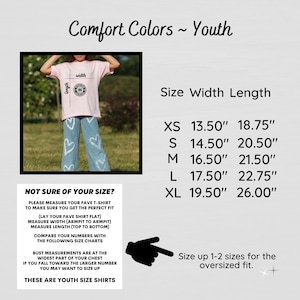 May include: Pink youth t-shirt with a circular design, paired with blue jeans. The image includes a size chart with measurements in inches for XS to XL sizes. Text reads "Comfort Colors ~ Youth".