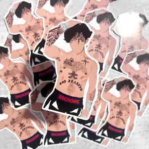May include: A collection of stickers depicting a shirtless figure with tattoos, black shorts with "HOOK" in red, and white wristbands. The figure has dark hair and various tattoos on the chest and arms.