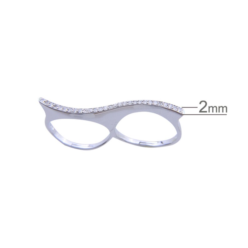 May include: Silver double finger ring with a wave design and a row of clear cubic zirconia stones. The ring is 2 mm wide.
