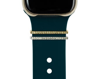 May include: A dark green silicone watch band with two decorative bands, one gold and one silver, each with a row of clear crystals.