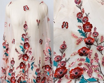 May include: White sheer fabric with embroidered red and pink flowers and butterflies. The fabric is embellished with sequins.