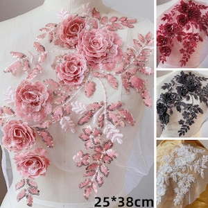 Op de afbeelding: Roze, rode, zwarte en witte bloemvormige kant-applicaties met pailletten. De applicaties zijn op een transparante mesh-achtergrond. De applicaties zijn ongeveer 25 bij 38 centimeter.