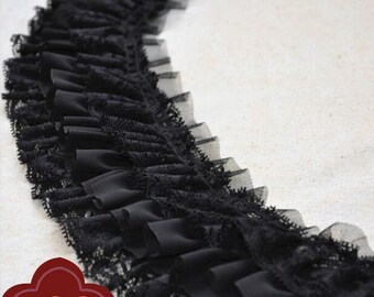 May include: Black lace trim with a ruffled edge. The trim is made of a soft, sheer fabric and has a delicate, feminine look.