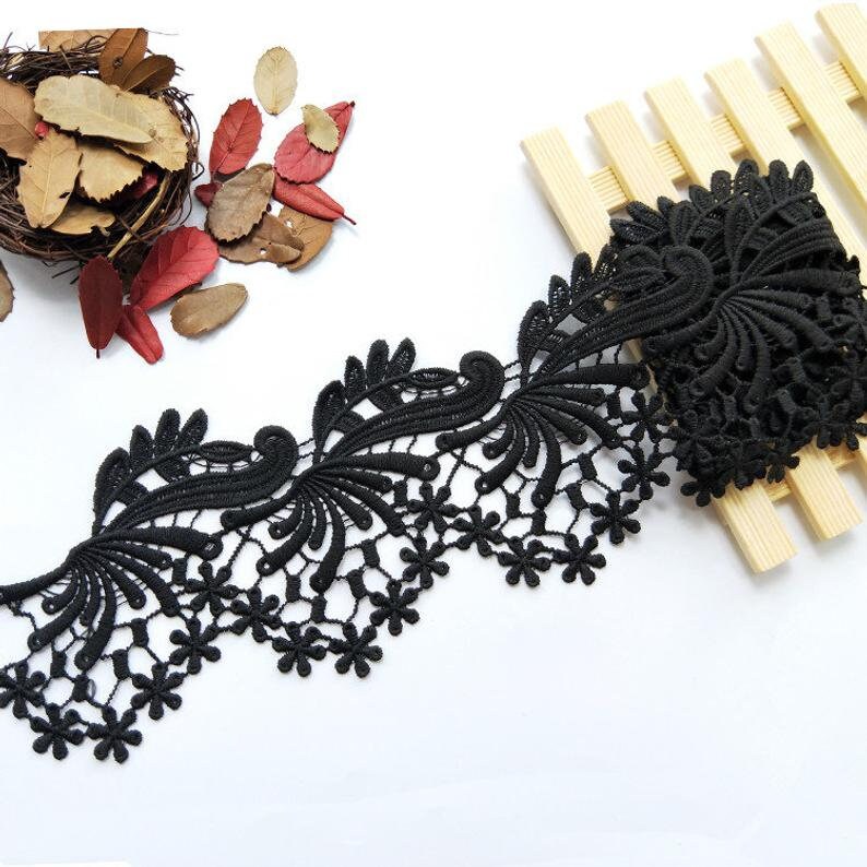 May include: Black lace trim with a floral design. The lace has a scalloped edge and is perfect for adding a touch of elegance to any project.
