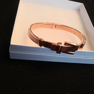 Peach enameled and rose gold MK bangle. Buckle detail clasp with Michael Kors logo engraved on clasp. Like new condition. Michael Kors
