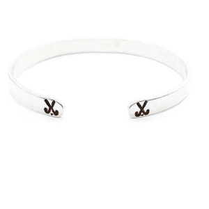May include: A silver bangle bracelet with two hockey stick symbols engraved on the ends.