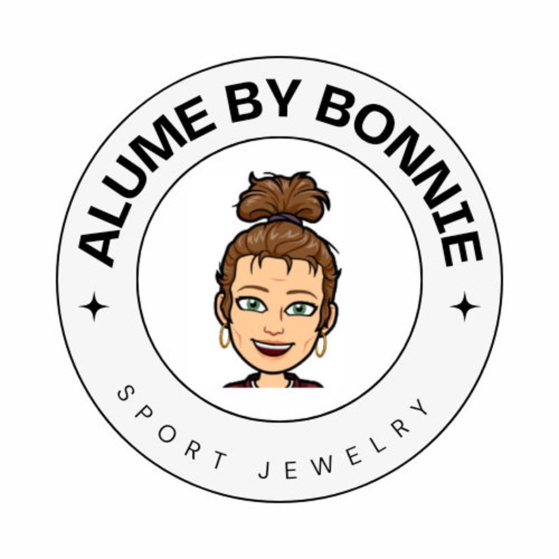 May include: A black and white logo with the text "ALUME BY BONNIE SPORT JEWELRY" in a circle. A cartoon woman with brown hair is in the centre of the circle.