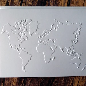 May include: A white card with an embossed world map design.