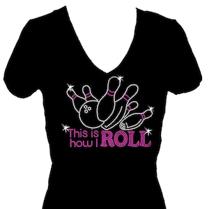 May include: Black v-neck t-shirt with a pink rhinestone design of bowling pins and the text "This is how I ROLL".