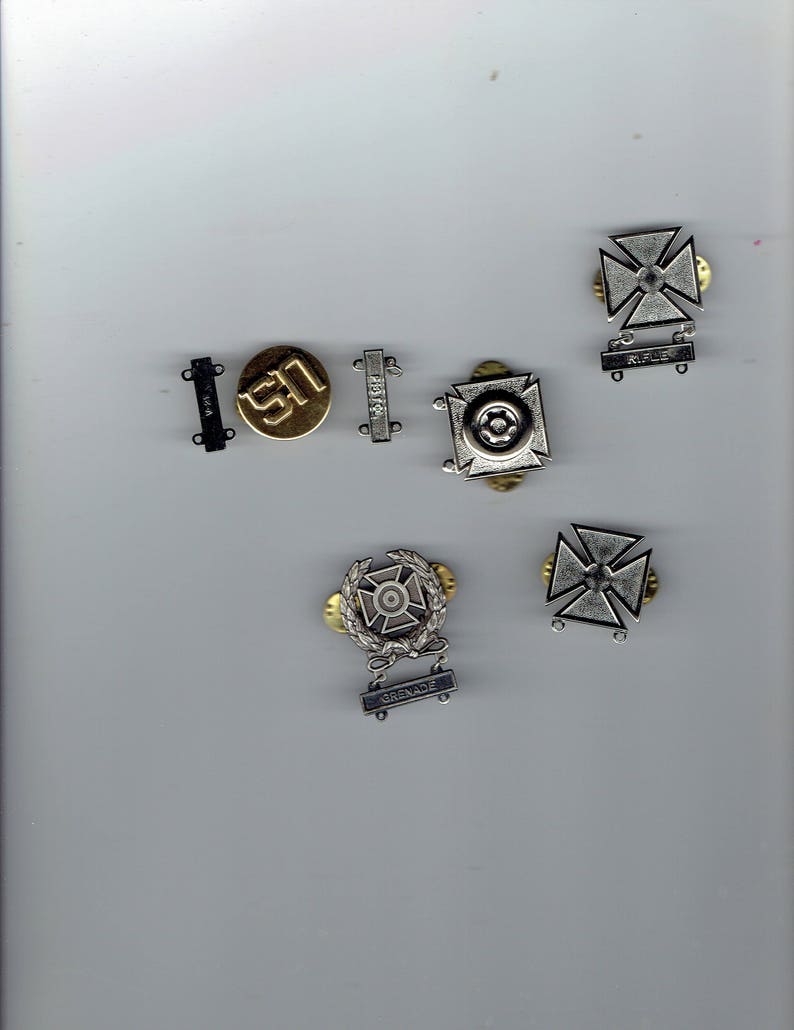 5 u.s.marksmanship pins earned during service.