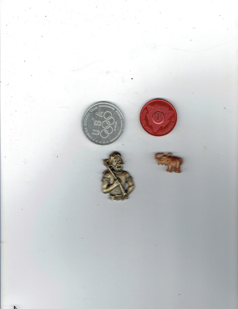 1 small elephant,1 miner,1-1996 olympic coin,1 self help coin
