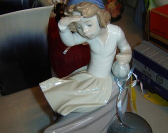 Lladro girl looking out to sea figurine