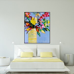 May include: A colorful abstract painting of a bouquet of flowers in a yellow striped vase on a light blue background. The painting is framed in black and has the artist's signature in the bottom right corner.